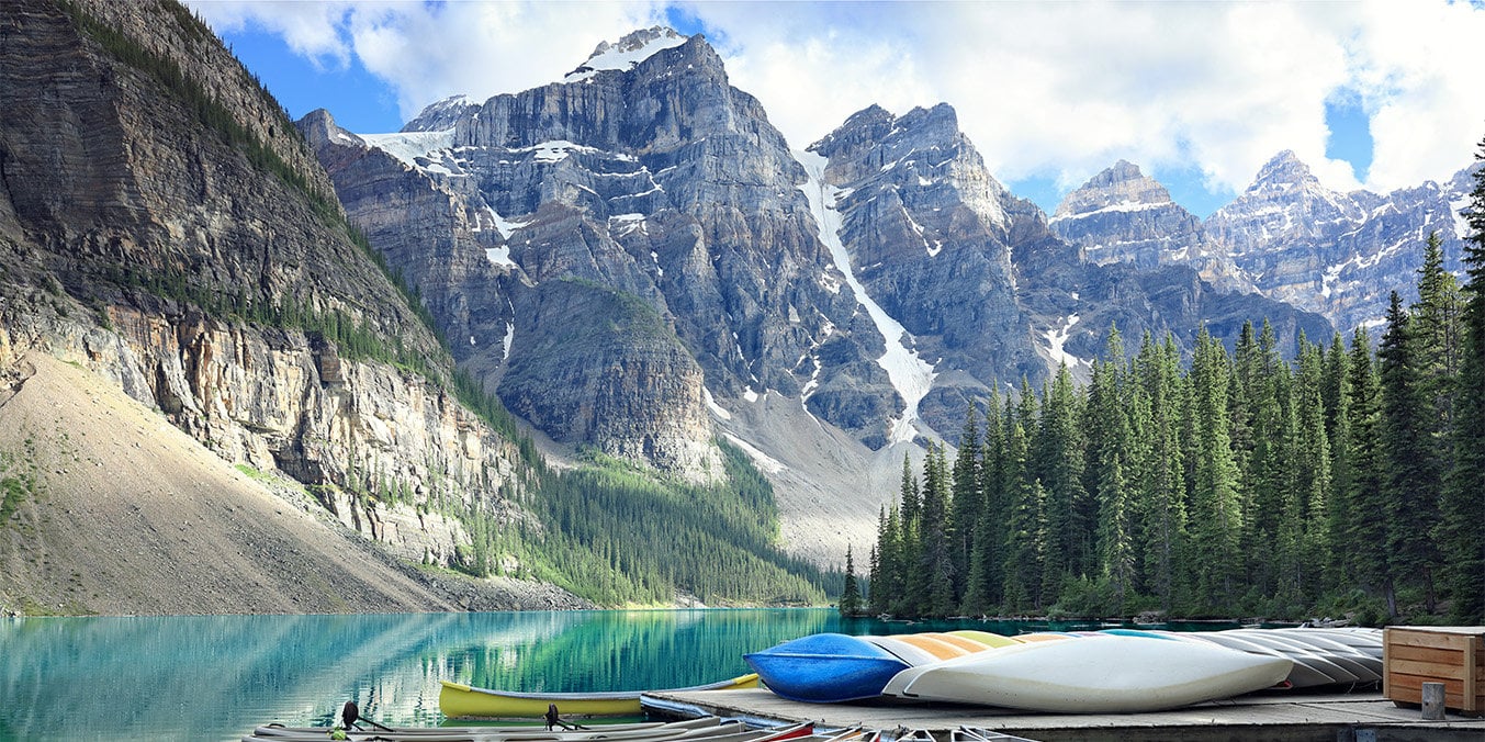 rock mountains with lake and boats