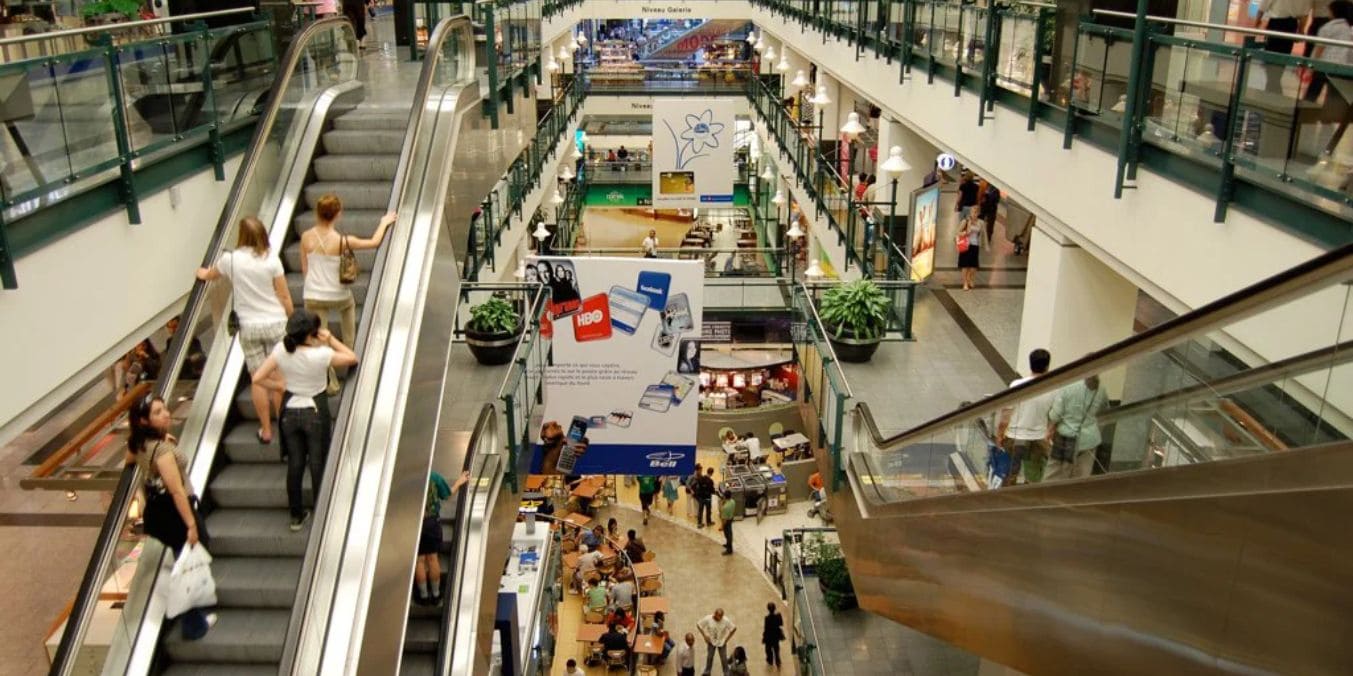 Interior of a bustling shopping mall illustrating the urban cultural vibrancy in cities, reflecting diverse social and cultural environments in Montreal and Vancouver