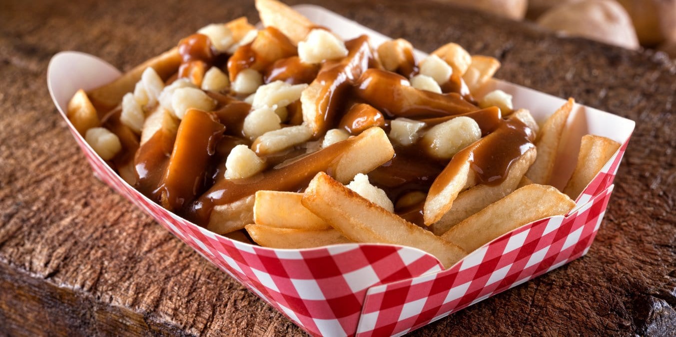 Poutine served on a wooden board as a budget-friendly dining option in Vancouver