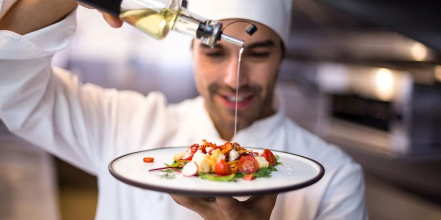 Chef preparing a gourmet dish, representing Montreal's traditional European dining alongside Vancouver’s fresh seafood and Asian culinary influences