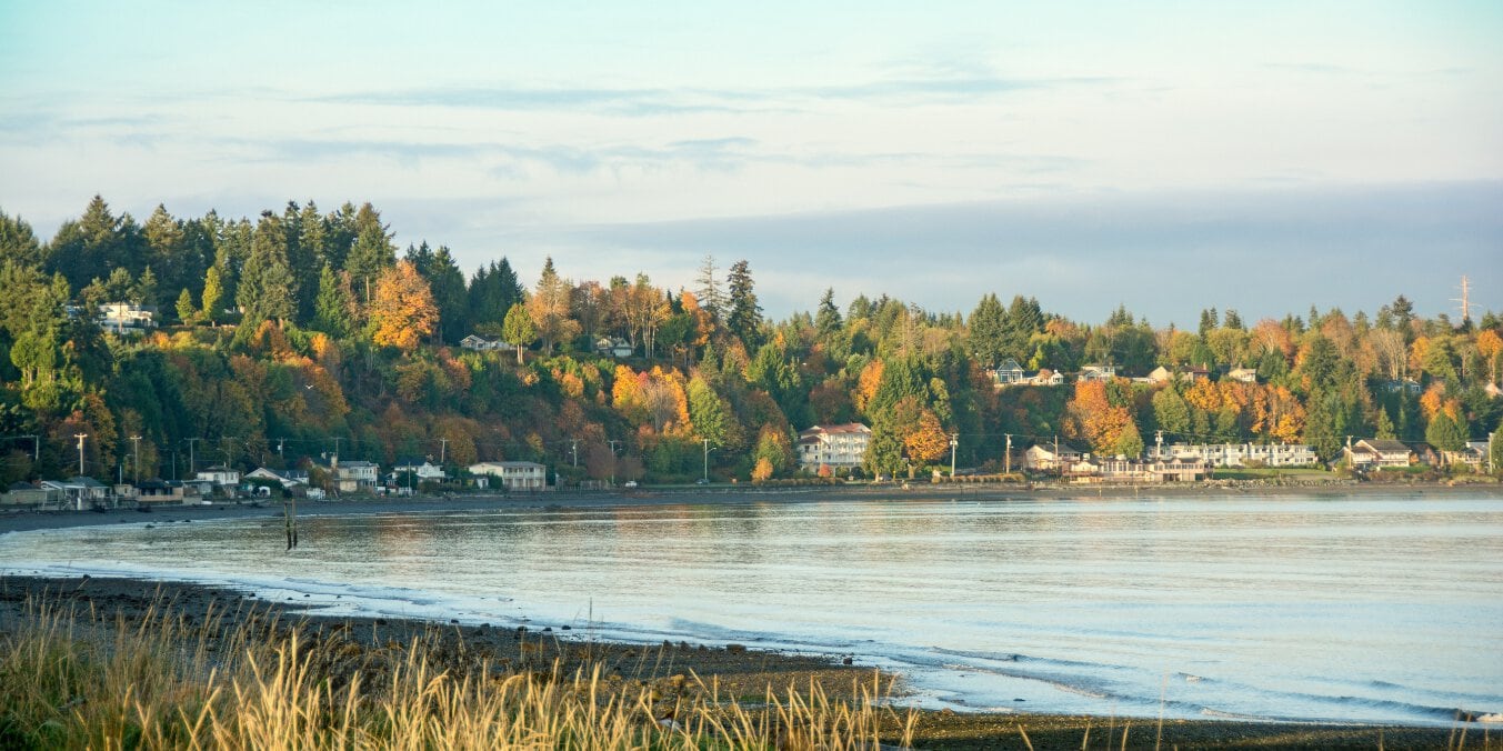 Coastal homes surrounded by autumn trees in Qualicum Beach, showcasing its appeal as one of the best places to live on Vancouver Island