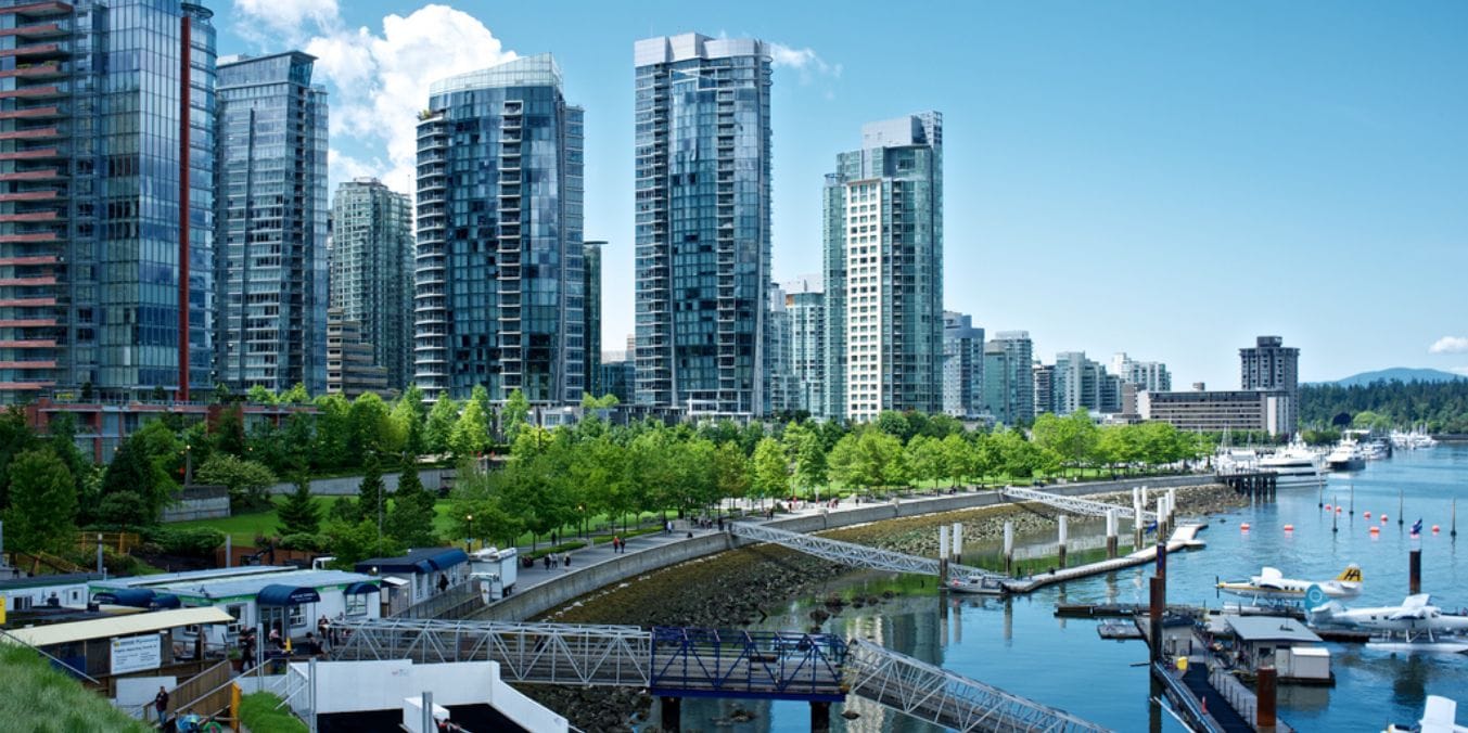 Vancouver's waterfront skyline with lush green spaces and modern architecture, exemplifying the city's commitment to green urban planning.