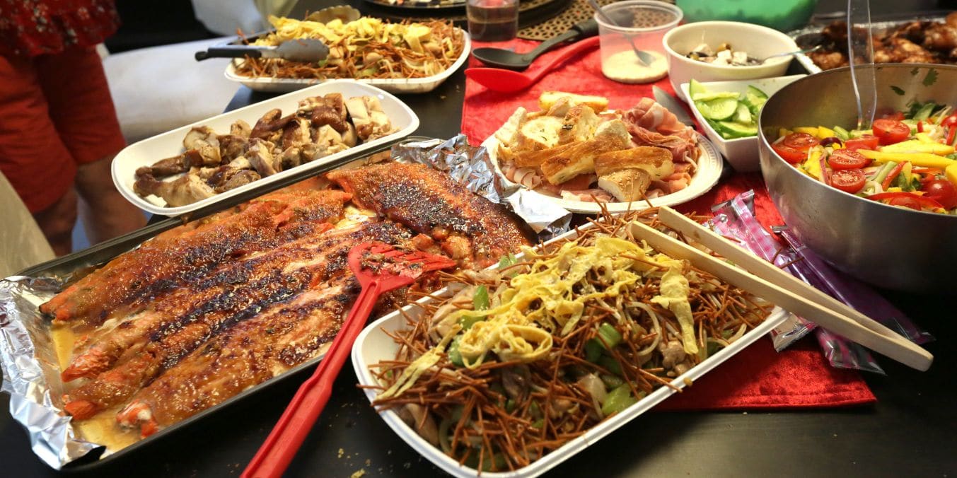 A table overflowing with a variety of dishes from different cultures, reflecting the diverse culinary scenes and dining options in Calgary vs Winnipeg.
