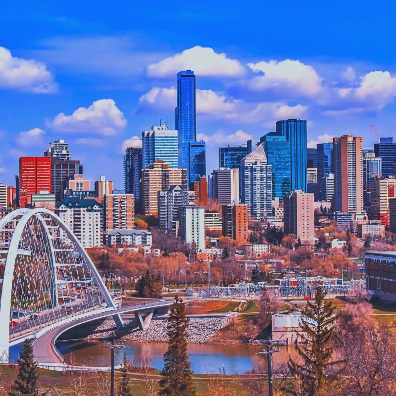 Skyline of Edmonton, Alberta, featuring modern skyscrapers, the iconic Walterdale Bridge, and the North Saskatchewan River, showcasing as one of the best neighborhoods.