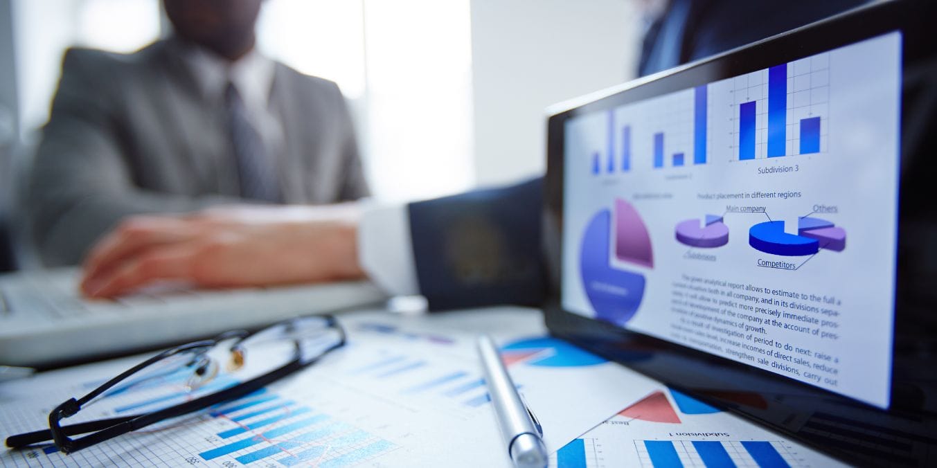 Business meeting with charts analyzing Edmonton and Vancouver's job markets and economic landscapes, highlighting key industries and opportunities.