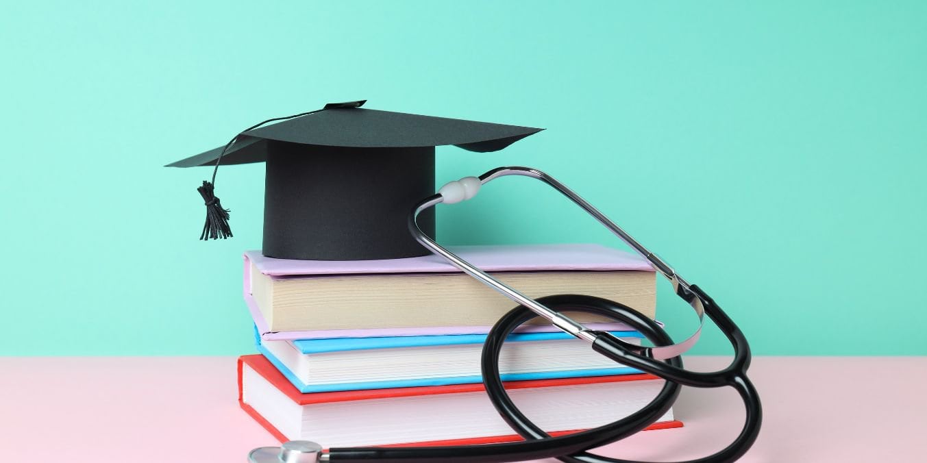 A graduation cap, books, and stethoscope symbolize the education and healthcare differences between Edmonton vs Vancouver.