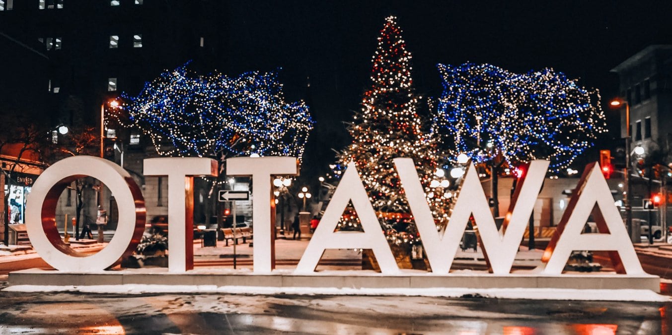 Illuminated Ottawa sign at night representing the city's culinary scene and nightlife