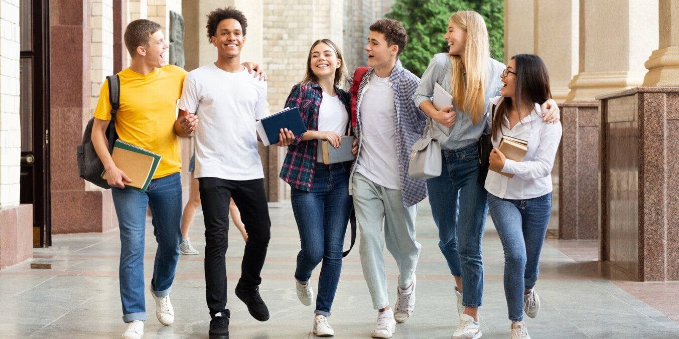 Group of diverse students walking and smiling, representing the best schools in Edmonton