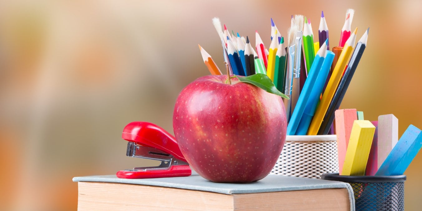 School supplies and apple symbolizing education and healthcare facilities when moving to Calgary from Vancouver