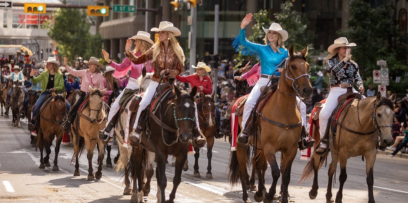 Riders in cowboy attire participating in the Calgary Stampede parade, a festival fun activity in Calgary