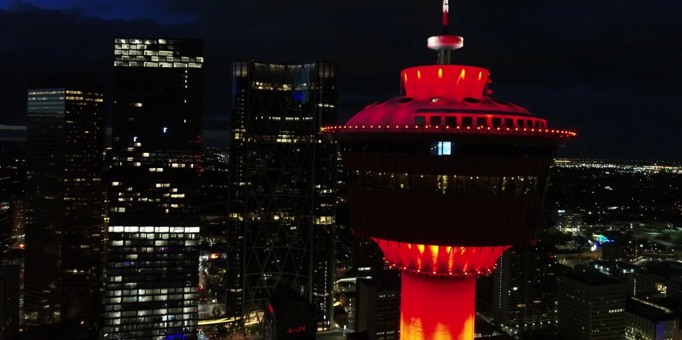 Calgary Tower lit up at night, offering iconic fun activities in Calgary with stunning city views