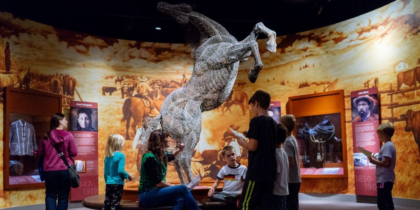 Visitors exploring an exhibit at Glenbow Museum, enjoying artistic fun activities in Calgary