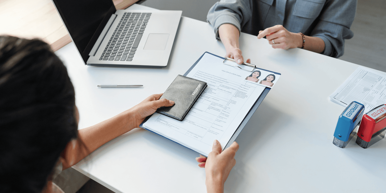 Canadian immigration consultant reviewing a client's visa application and passport, assisting with the immigration process.