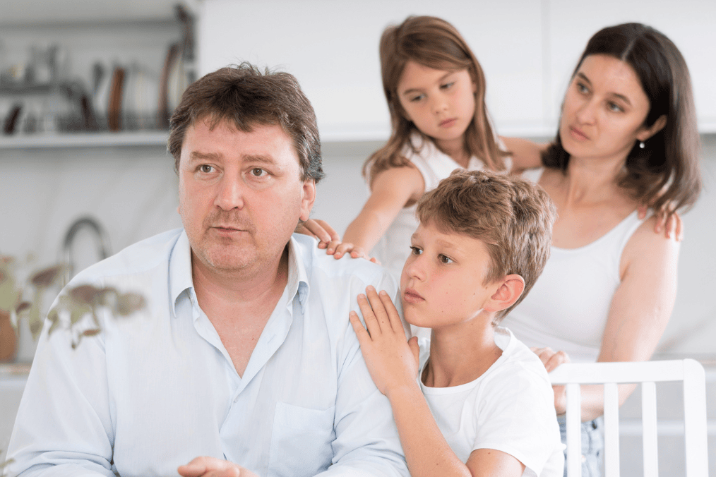 Family sitting together with serious expressions. Represents the emotional challenges in a conjugal relationship. What is conjugal relationship?