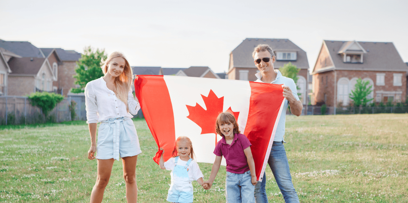 A happy family holds a large Canadian flag in a suburban neighborhood, symbolizing the benefits of marrying a Canadian citizen and building a future in Canada.