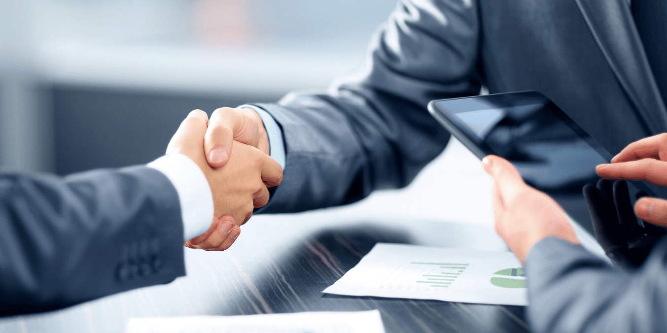 Business handshake with tablet and documents, representing sponsorship agreement in Canada. How long are you financially responsible for someone you sponsor in Canada?