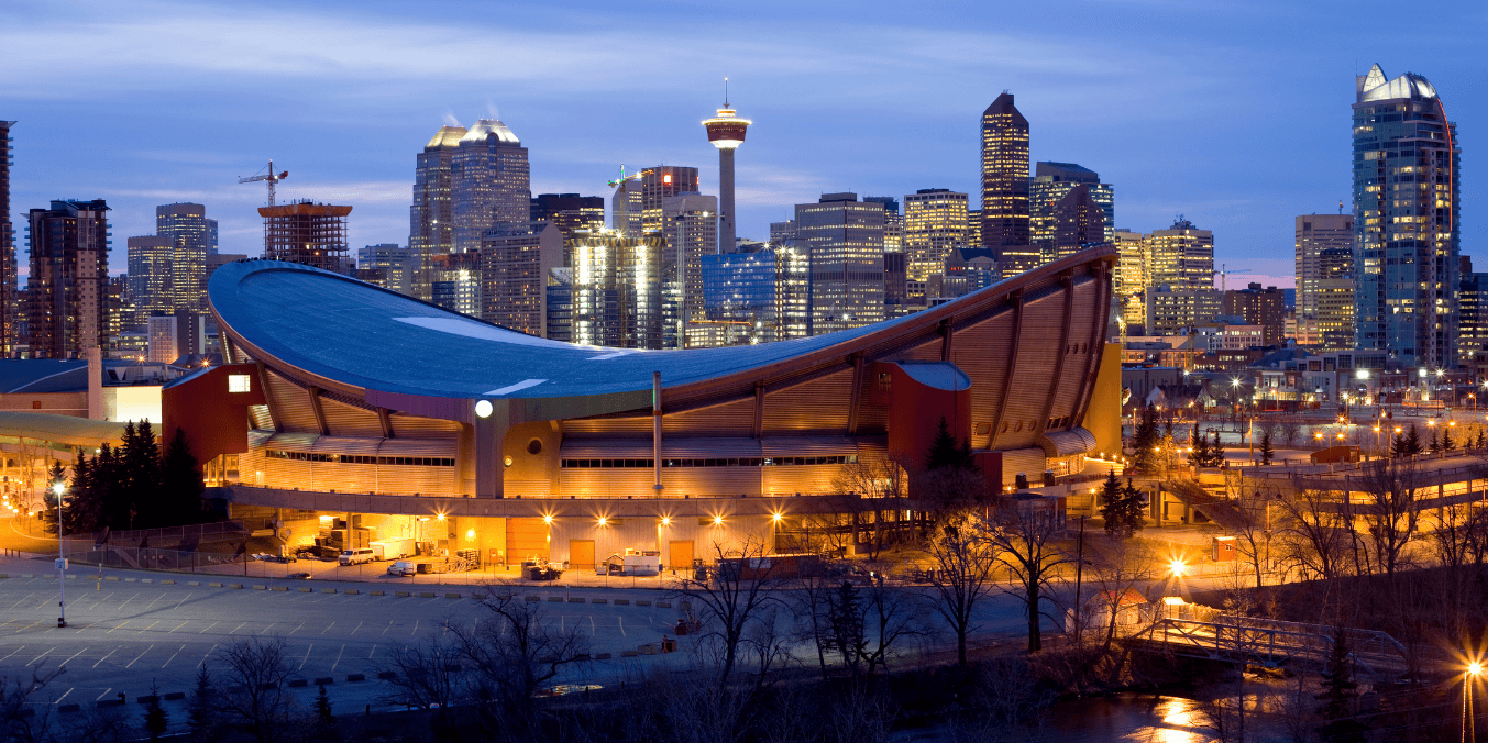 Calgary skyline at dusk featuring the iconic Saddledome, illustrating the city's vibrant lifestyle and raising the question, 