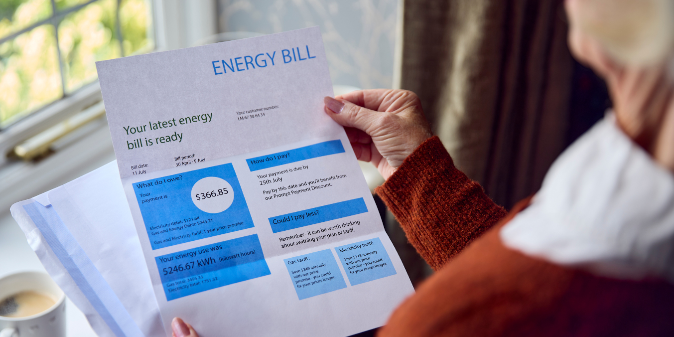 A person reviewing an energy bill, highlighting the cost of living considerations when comparing life in Canada vs Australia.