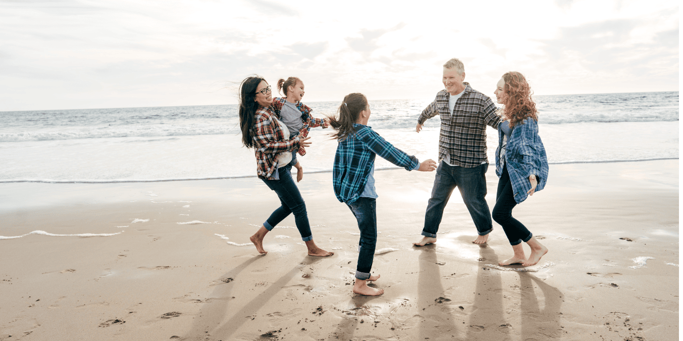 Family enjoying time together on a beach in Canada, highlighting the outdoor lifestyle and quality of life in Canada.