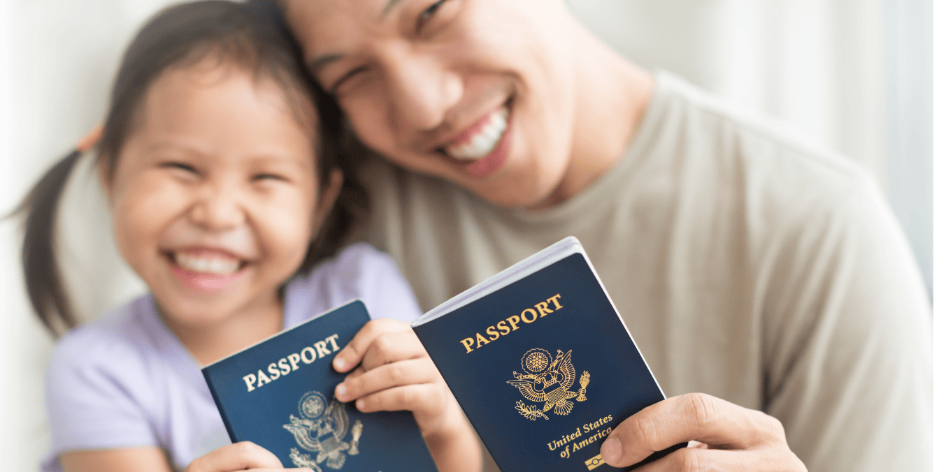 Smiling father and daughter holding passports, representing immigration and citizenship in life in Canada vs Germany.