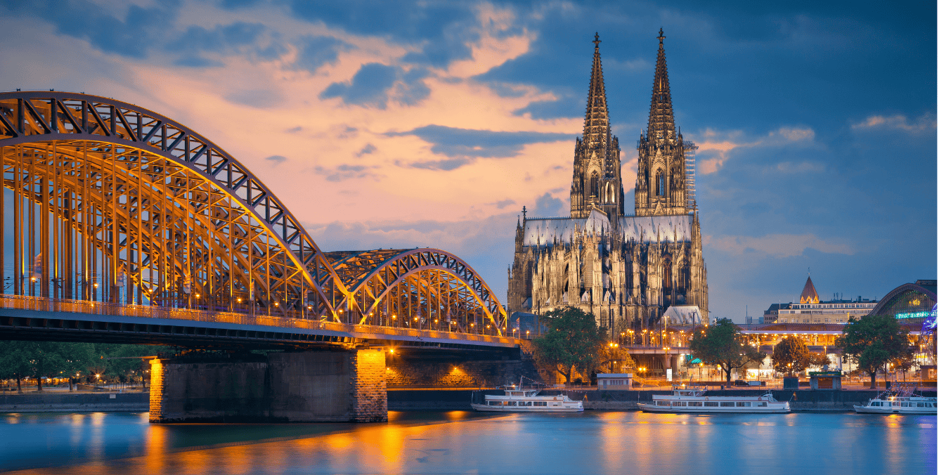 Scenic view of Cologne Cathedral and Hohenzollern Bridge at dusk in Germany, highlighting architecture and life in Germany