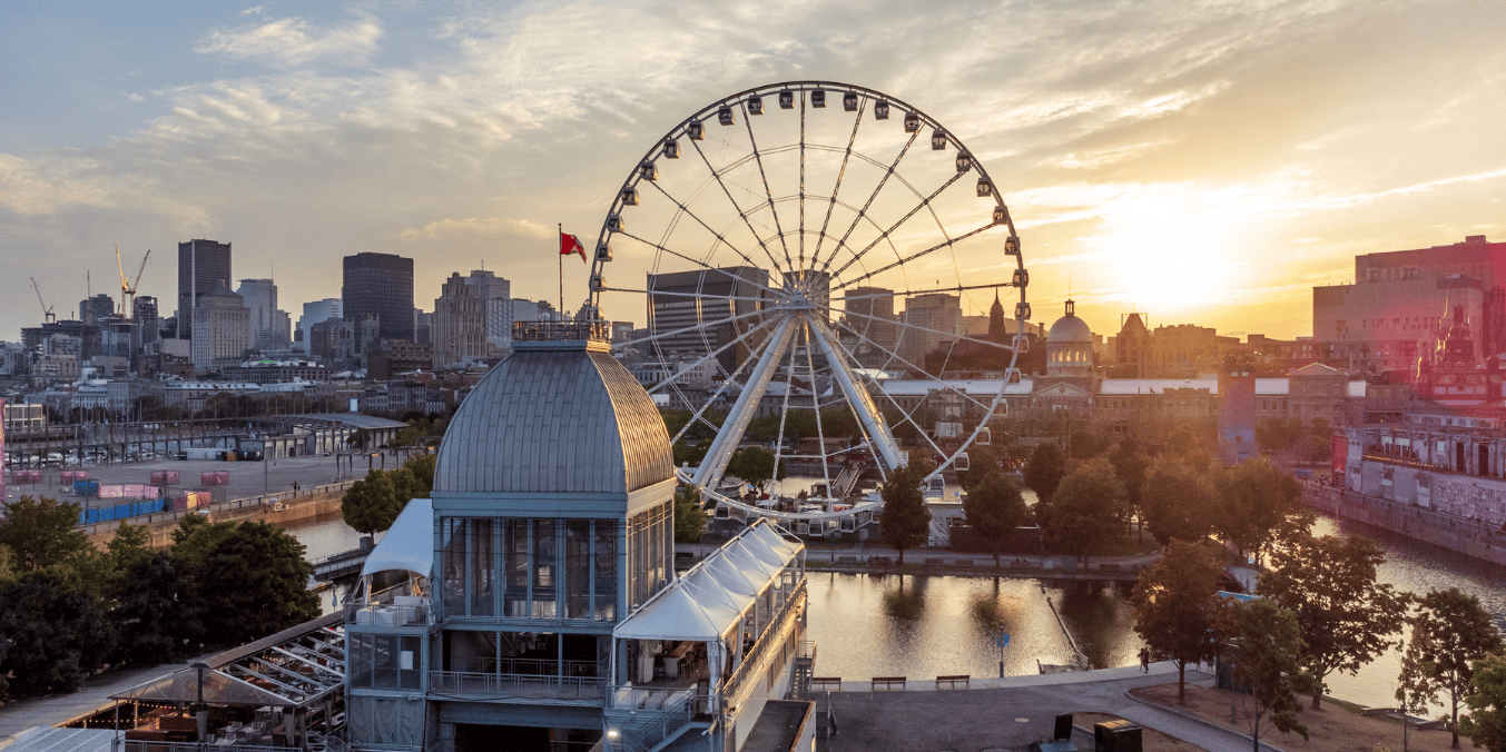 A scenic view of life in Canada vs Ireland, showcasing a ferris wheel and the skyline of Montreal, Canada, at sunset, with modern and historic buildings, a waterfront, and vibrant urban life.