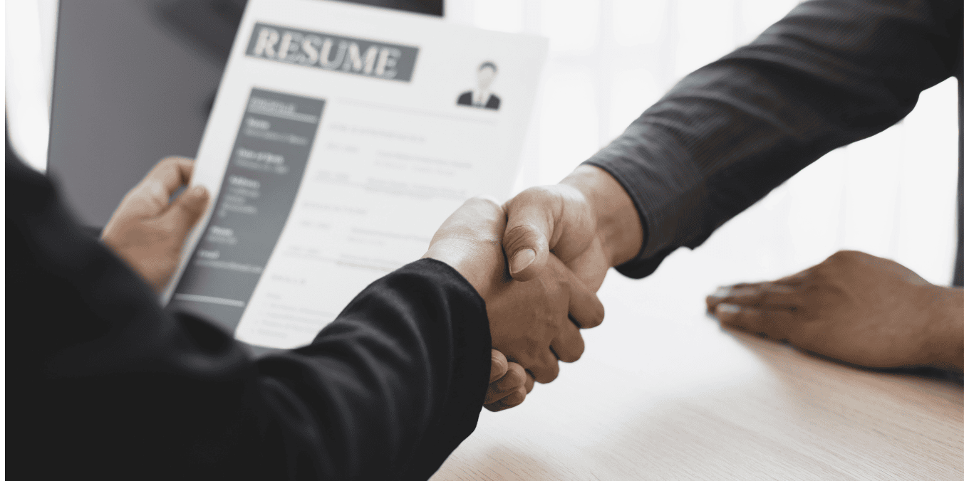 Handshake during a job interview with a resume in hand – exploring the top 10 highest paying jobs in Canada for 2024