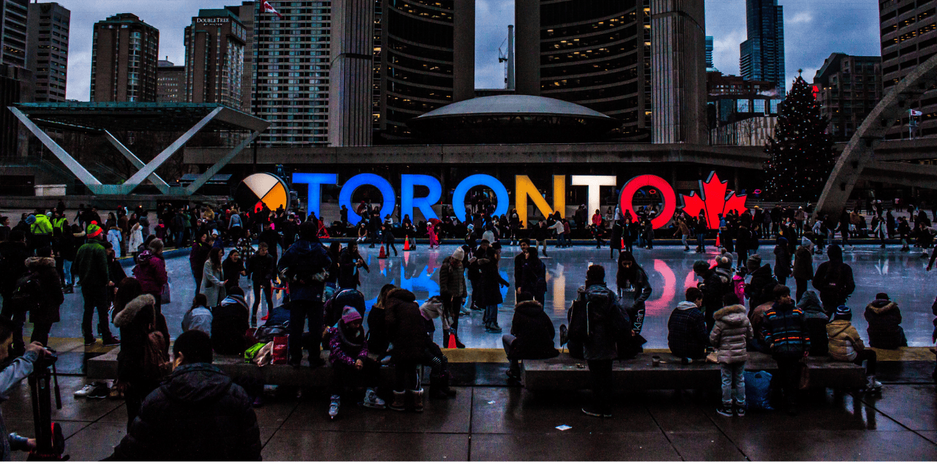 Crowds enjoying winter activities at Nathan Phillips Square in Toronto, one of the safest cities in Canada.