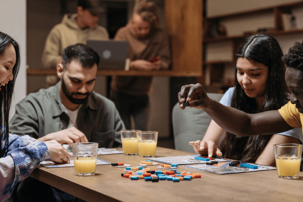 A group of friends enjoying a board game together, showcasing the social connections built through Vancouver social groups.