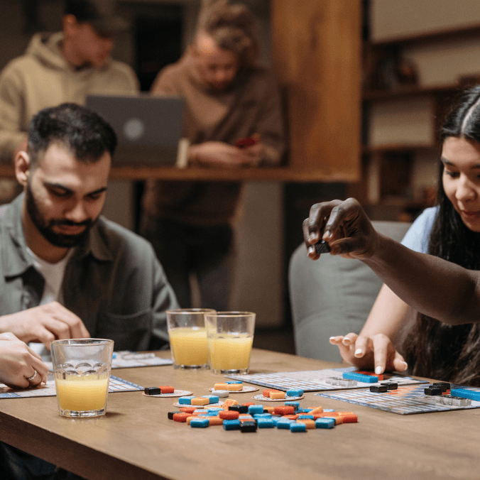 A group of friends enjoying a board game together, showcasing the social connections built through Vancouver social groups.