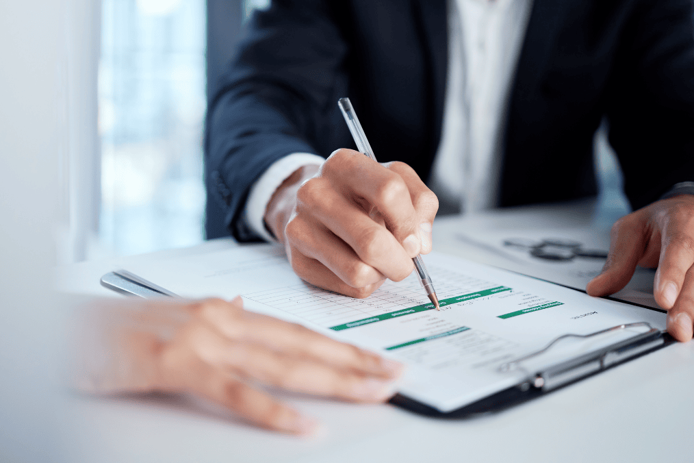 Person filling out a form on a clipboard, representing the Canada PR application process in 2024.