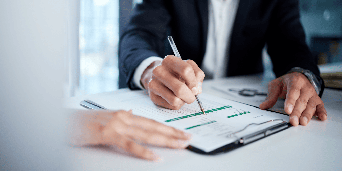 Person filling out a form on a clipboard, representing the Canada PR application process in 2024.