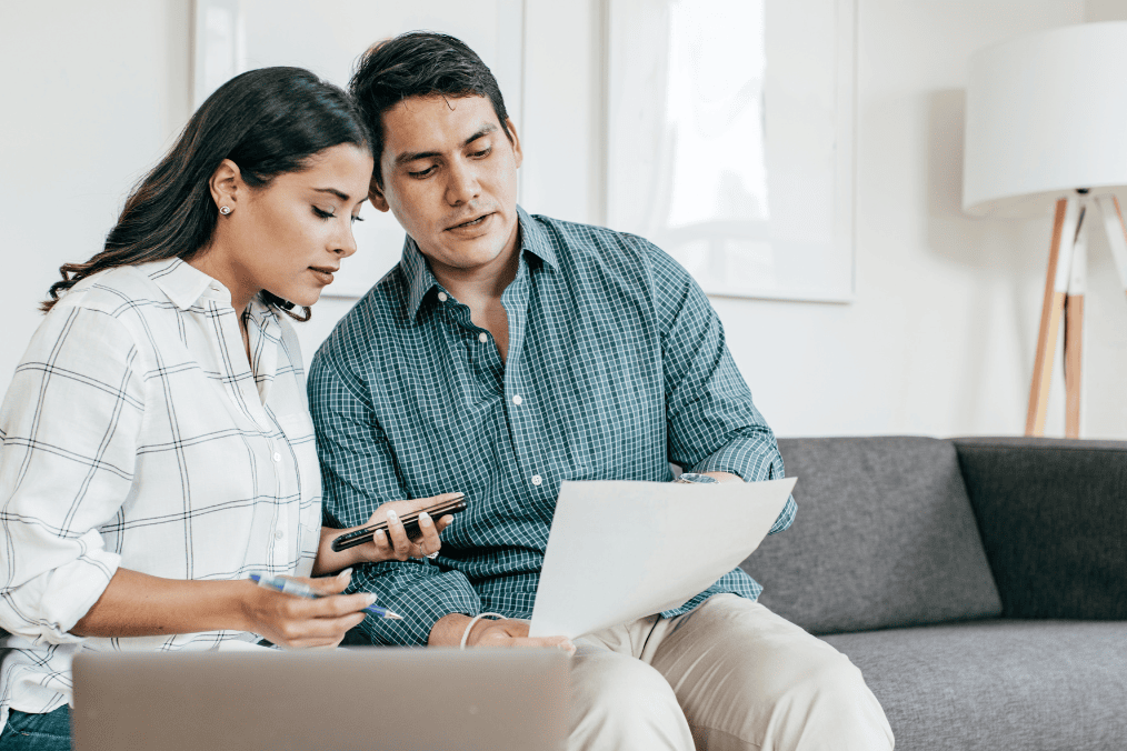 Couple reviewing bank statement for Express Entry proof of funds requirement for Canada PR application.