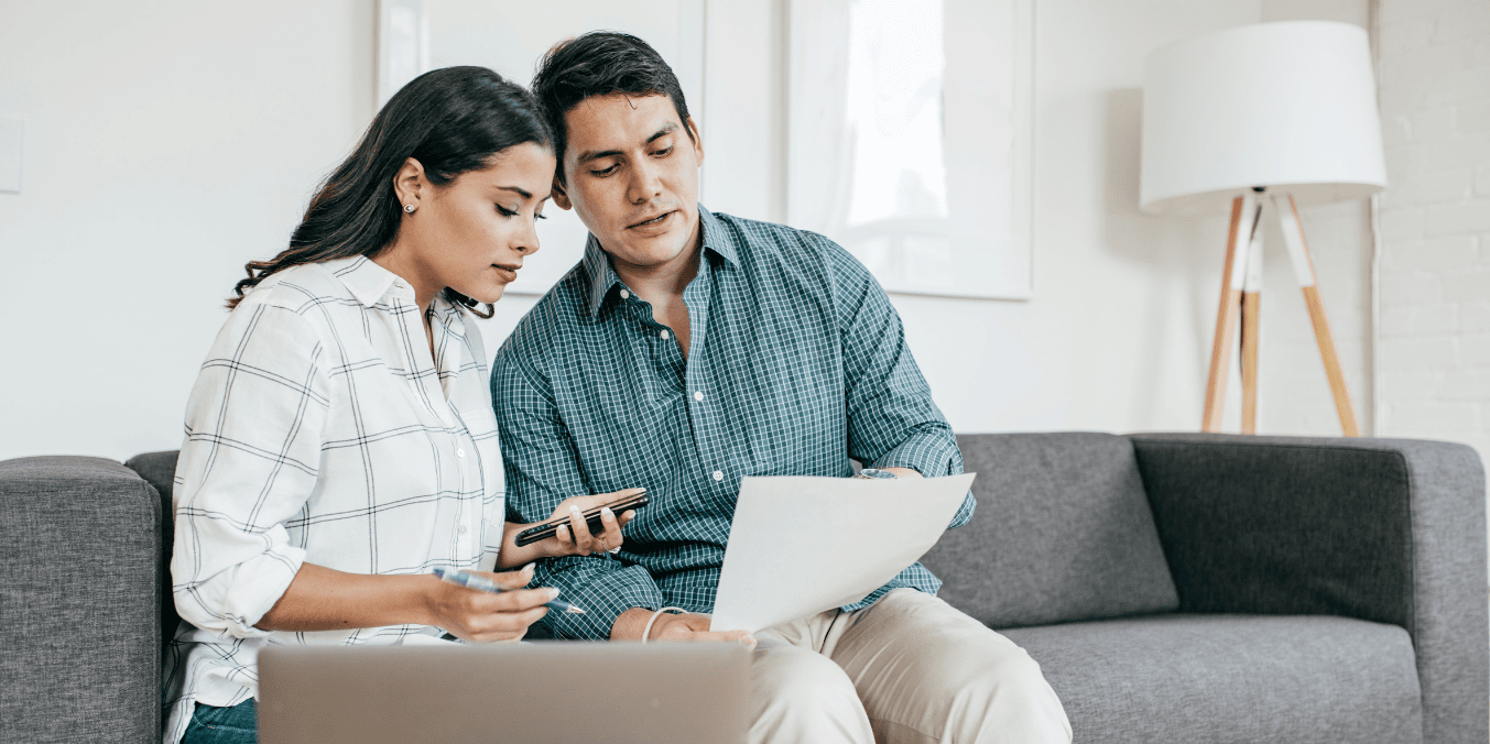 Couple reviewing bank statement for Express Entry proof of funds requirement for Canada PR application.