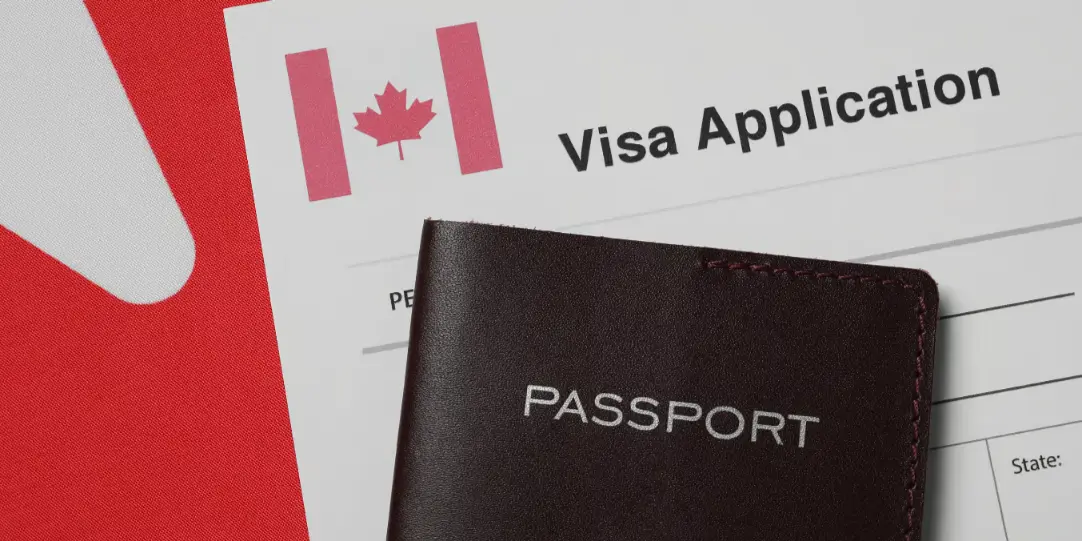 Temporary Resident Visa Canada application form with a passport placed on top, featuring a Canadian flag symbol.