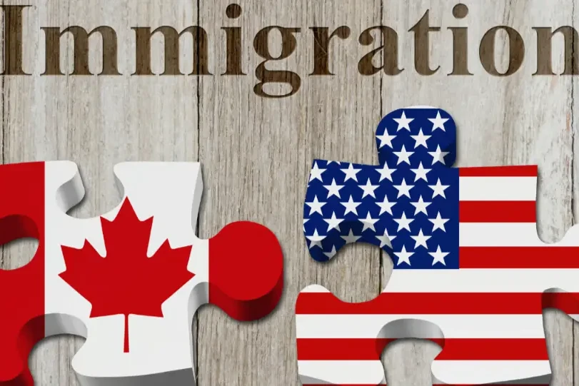 Canadian and U.S. flags on puzzle pieces fitting together, symbolizing the connection and complexities of immigration between Canada and the United States.